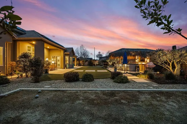 a view of a street with cars parked in front of it