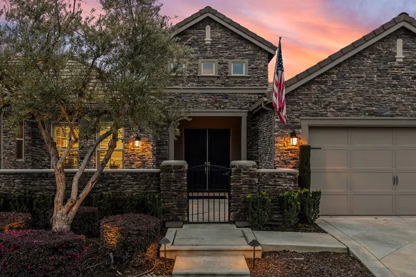 a front view of a house with garden