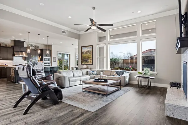 a living room with furniture a flat screen tv and a fireplace