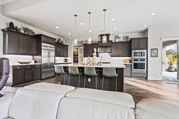 a kitchen with a table chairs stove and cabinets