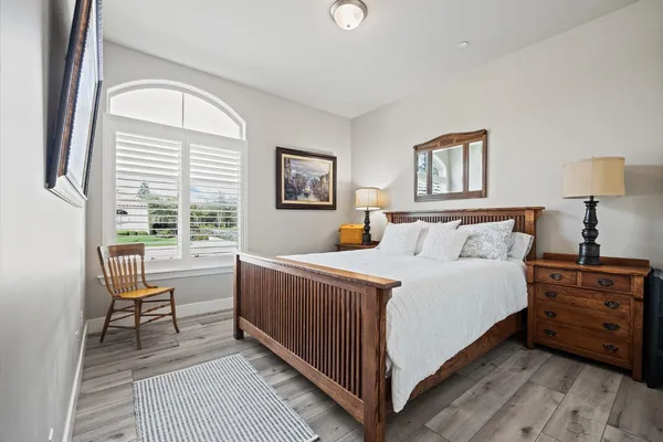 a bed room with a bed and a chair