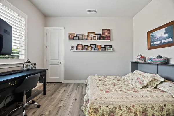 a bedroom with a bed and a flat screen tv