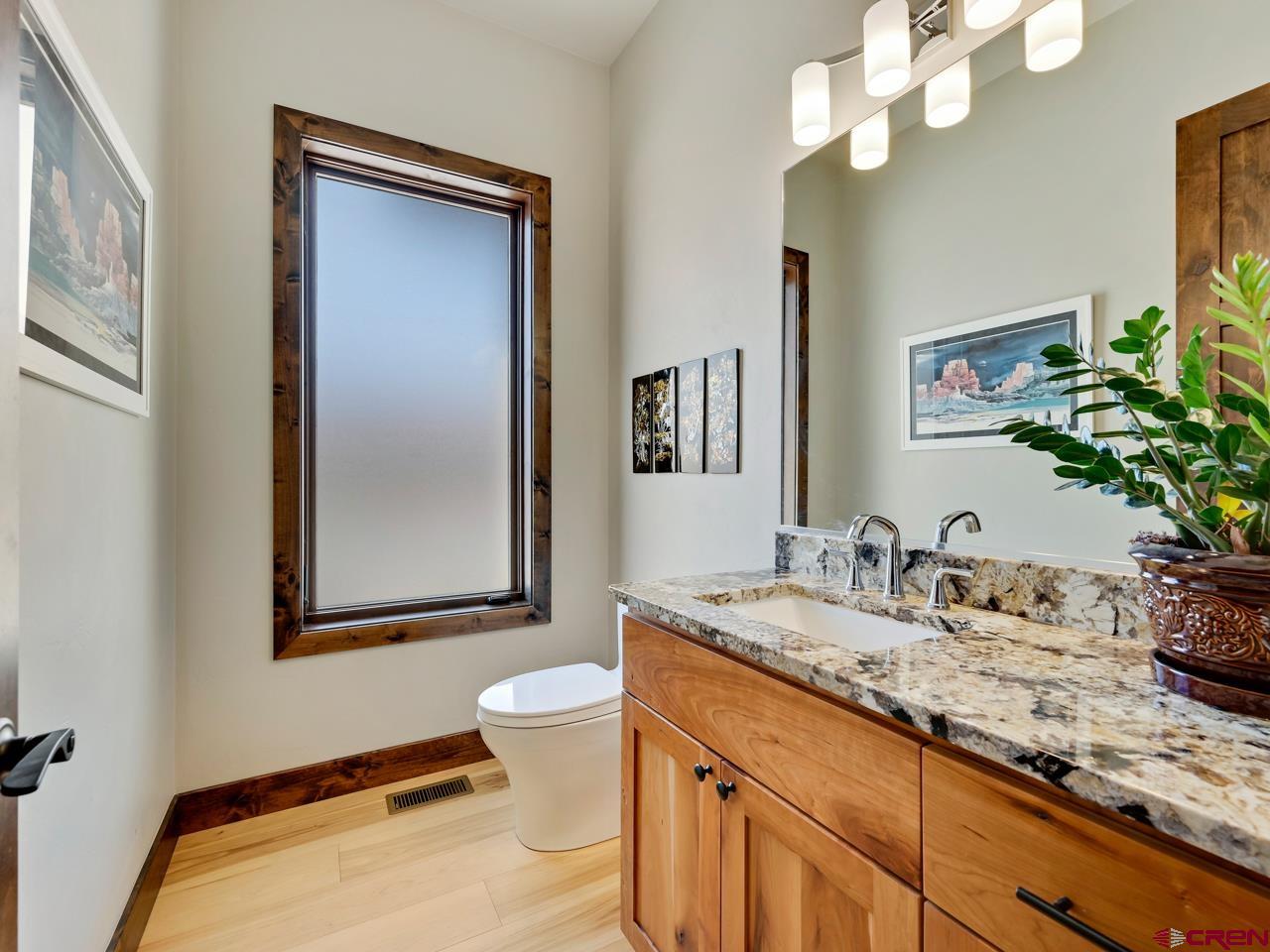 808 18 Road Grand Junction, CO 81507 - Photo 12 of 35 a bathroom with a granite countertop sink and a mirror