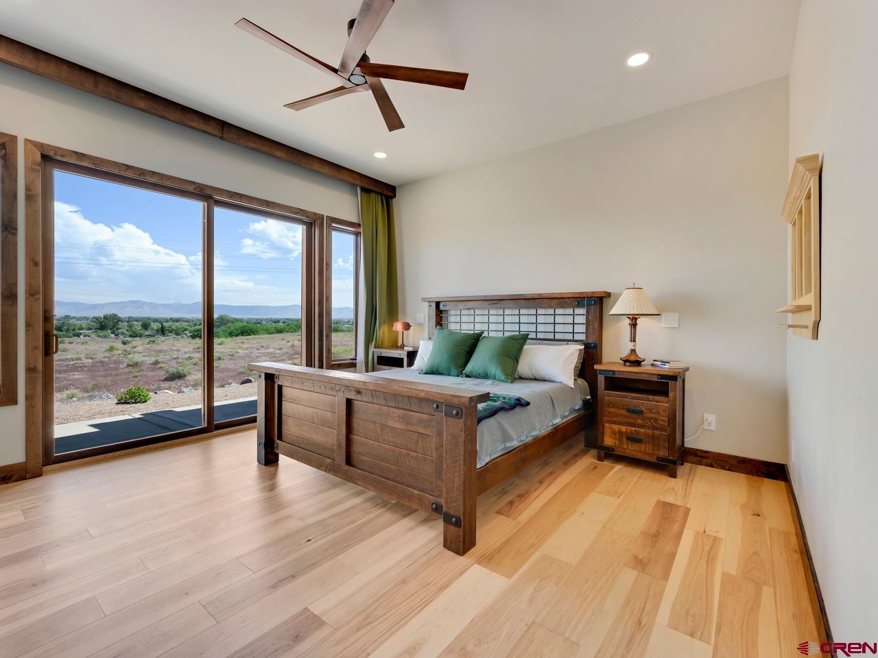 808 18 Road Grand Junction, CO 81507 - Photo 14 of 35 a bedroom with furniture and large windows
