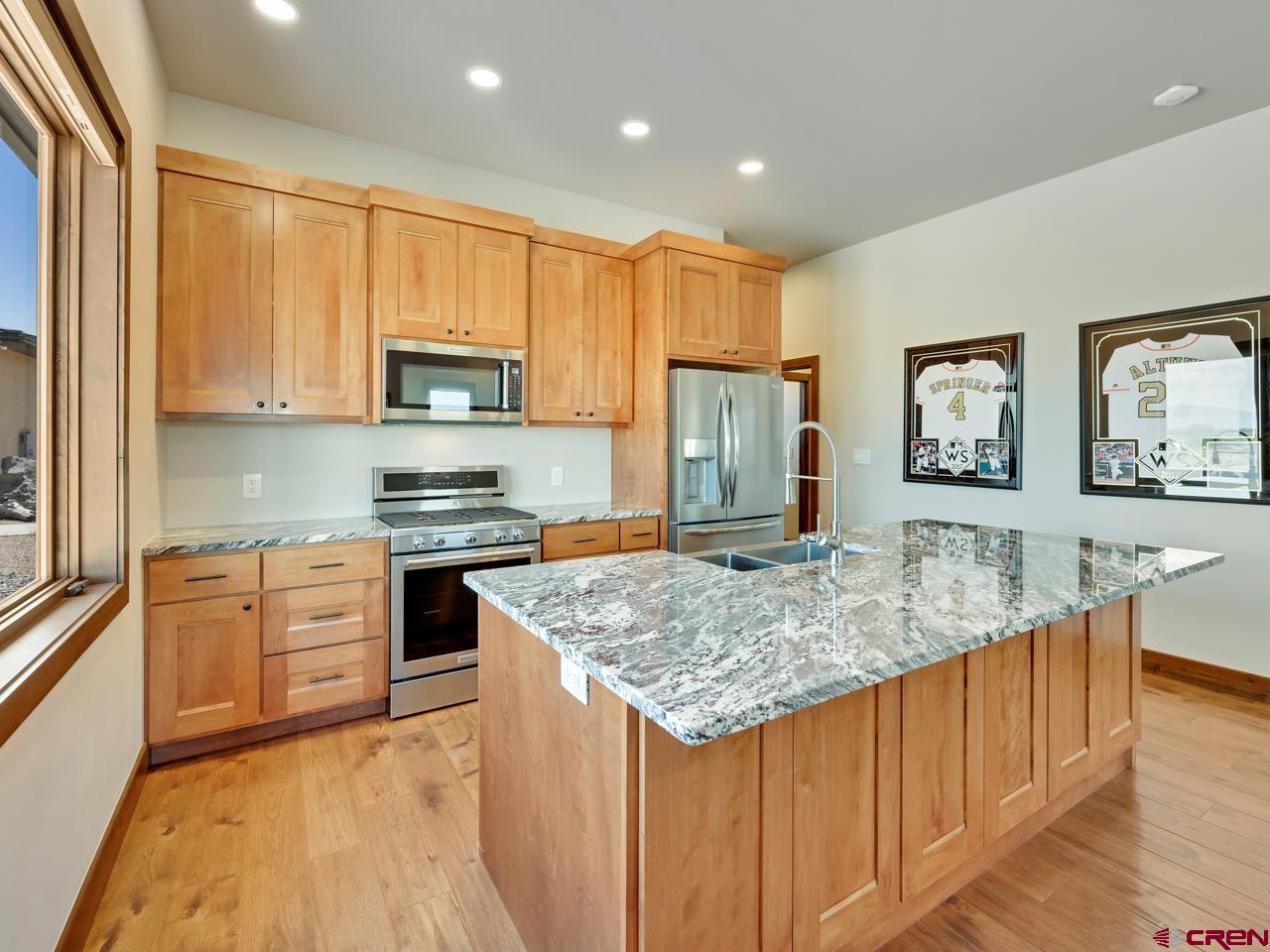 808 18 Road Grand Junction, CO 81507 - Photo 26 of 35 a kitchen with stainless steel appliances granite countertop a stove a sink a microwave a refrigerator and cabinets