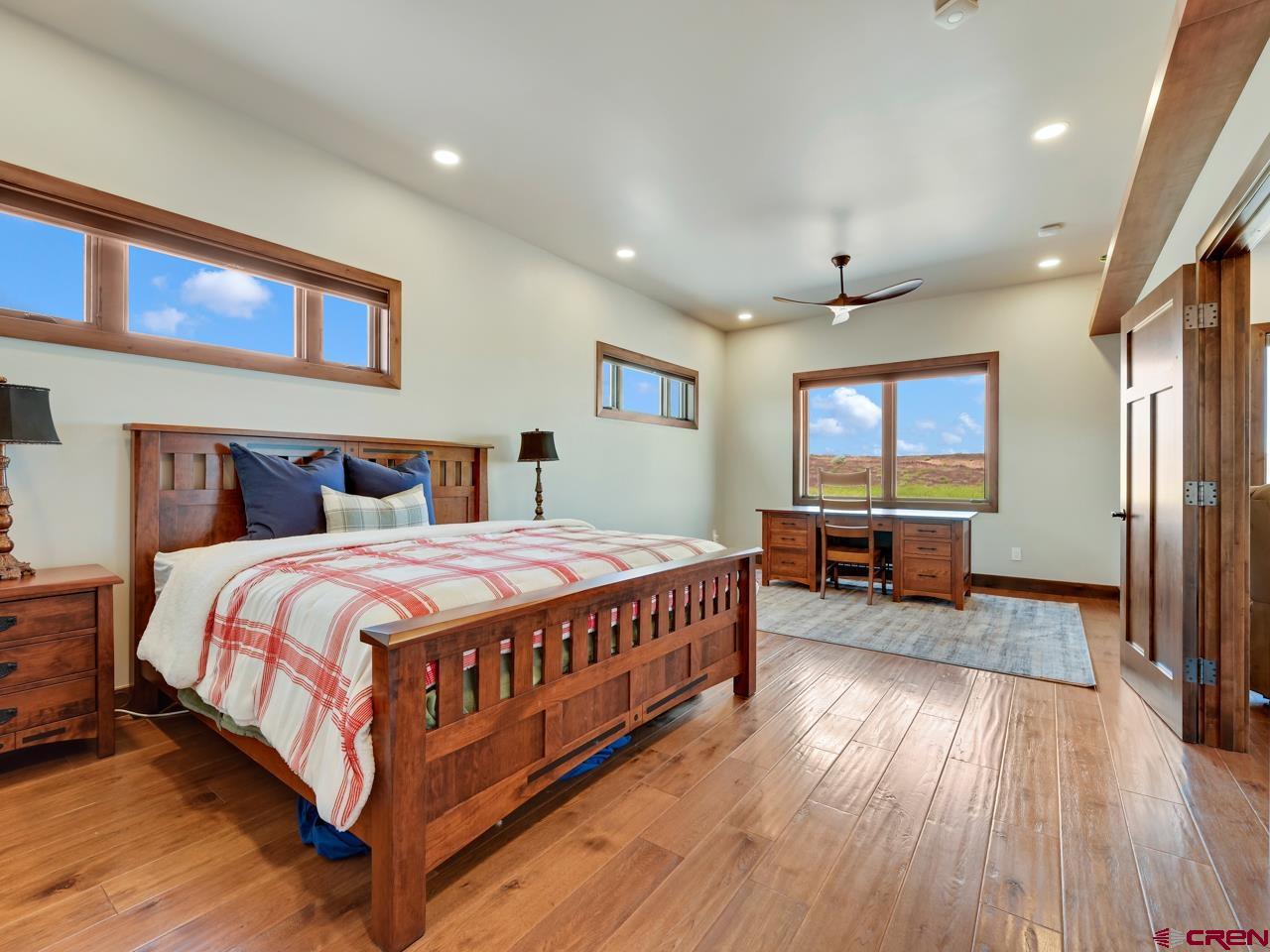 808 18 Road Grand Junction, CO 81507 - Photo 27 of 35 a spacious bedroom with a bed and a flat screen tv