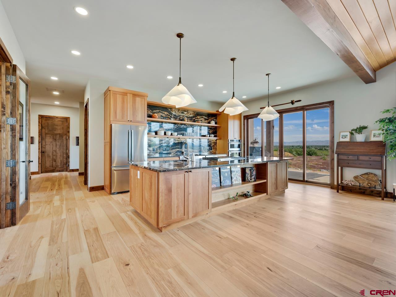 808 18 Road Grand Junction, CO 81507 - Photo 7 of 35 a room with lots of wooden furniture and large windows