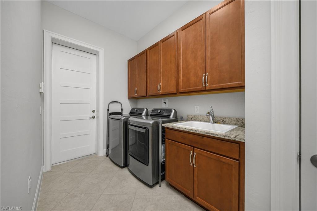 6552 Dominica Drive, Unit 101 Naples, FL 34113 - Photo 25 of 50 a utility room with sink dryer and washer