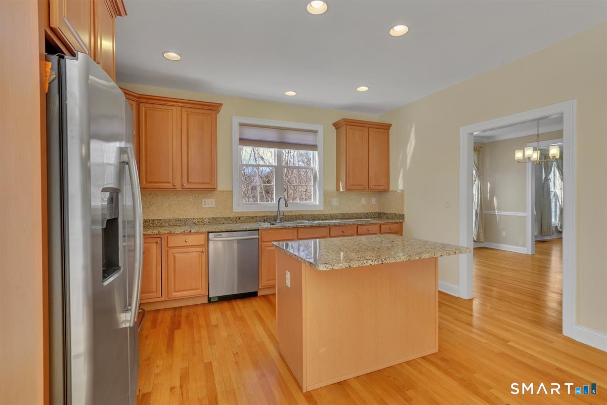 25 Fenwick Drive Avon, CT 06001 - Photo 8 of 40 a kitchen with stainless steel appliances granite countertop a refrigerator a sink dishwasher and a stove with wooden floor