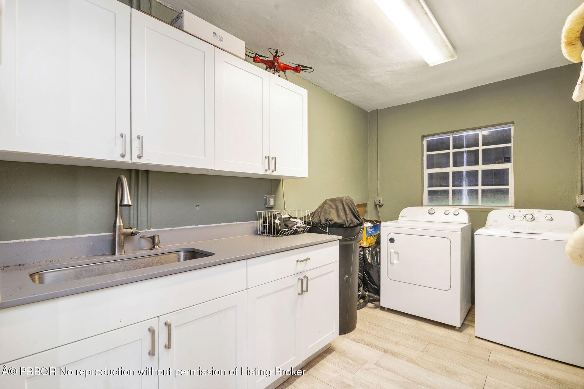 2770 E Road Loxahatchee, FL 33470 - Photo 15 of 51 a kitchen with a sink stove and cabinets