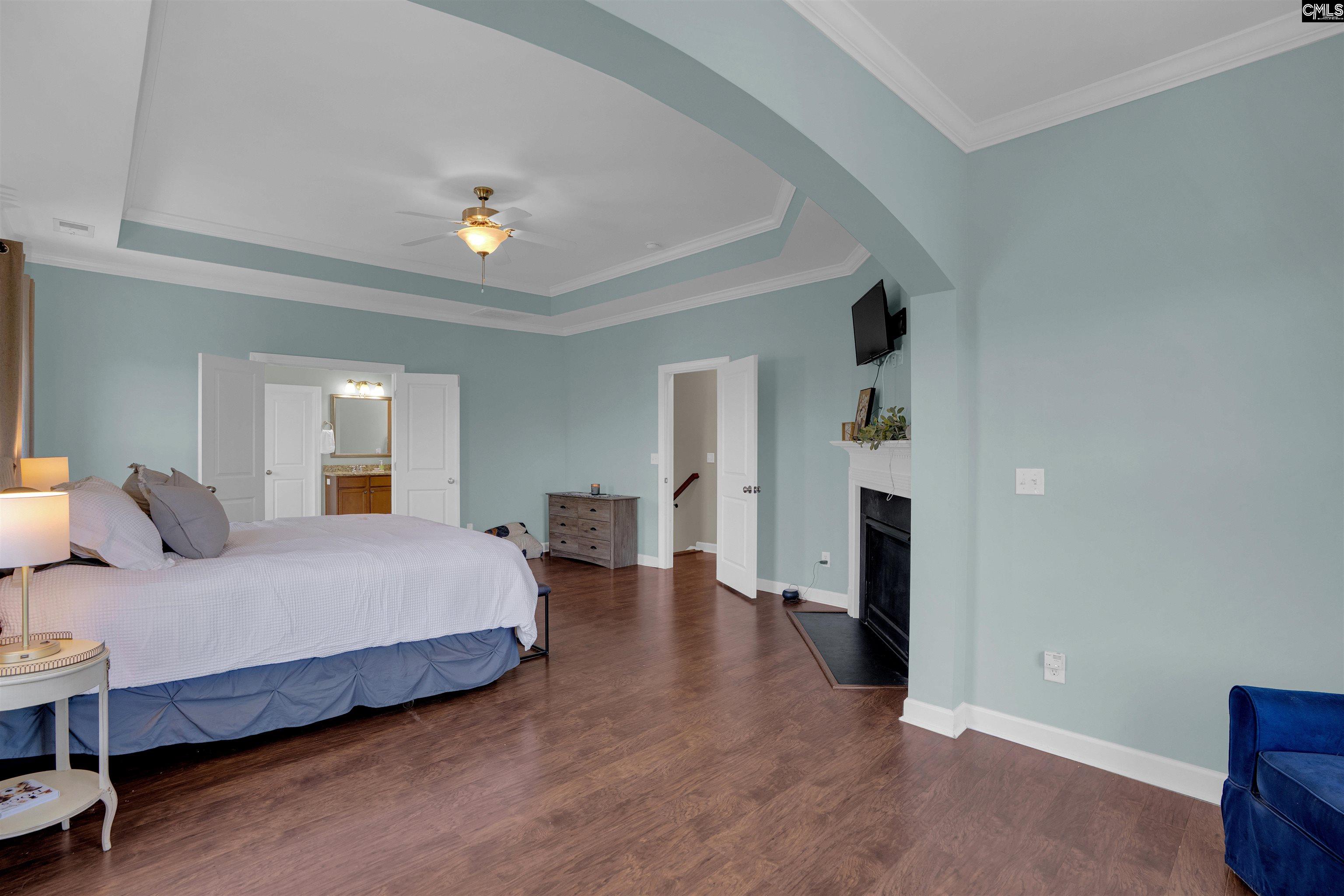 321 Asa Rose Lexington, SC 29072 - Photo 26 of 52 a bedroom with a bed and a chandelier