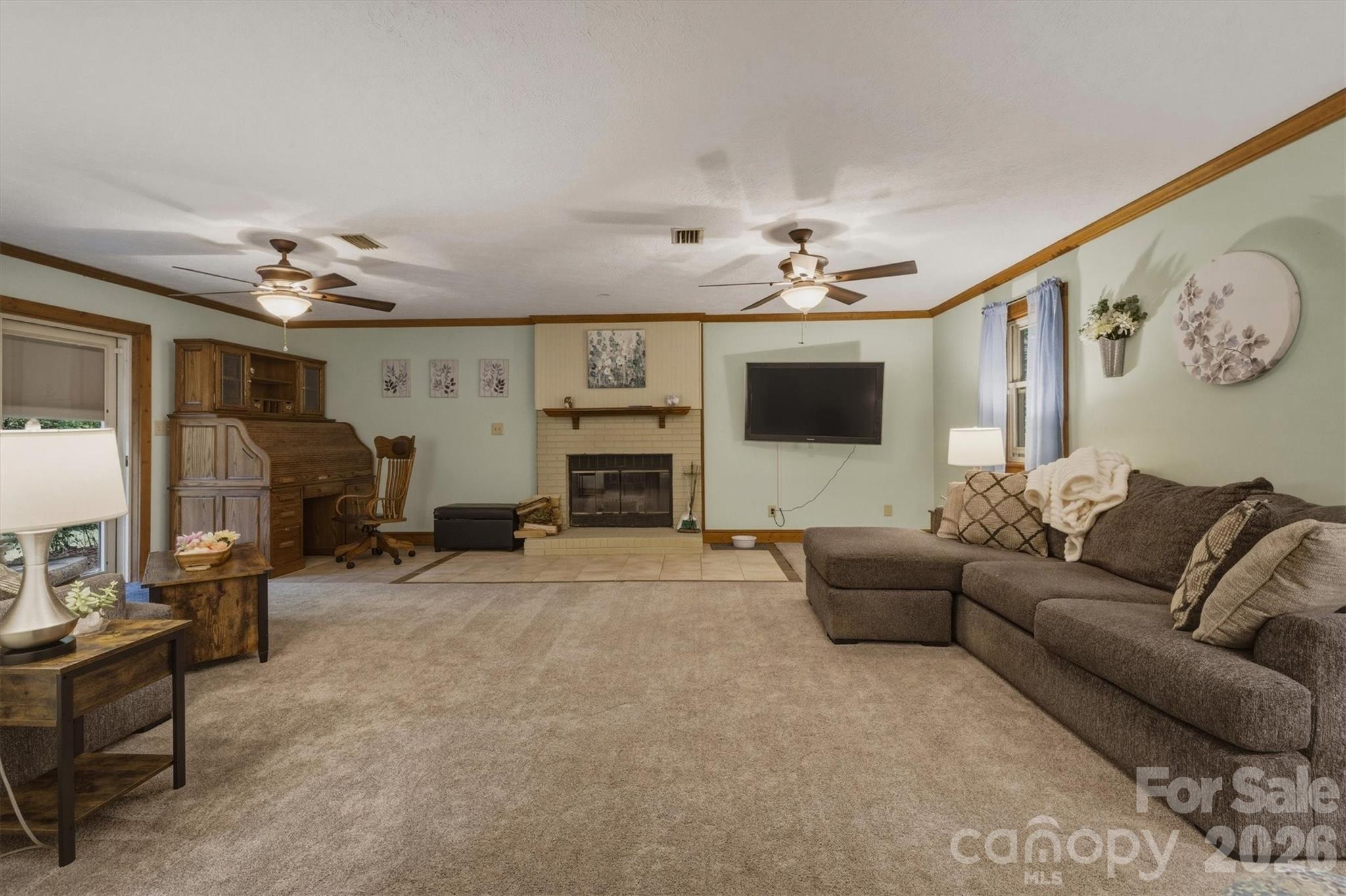 3432 Ridgewood Drive Morganton, NC 28655 - Photo 14 of 36 a living room with furniture a flat screen tv and a fireplace