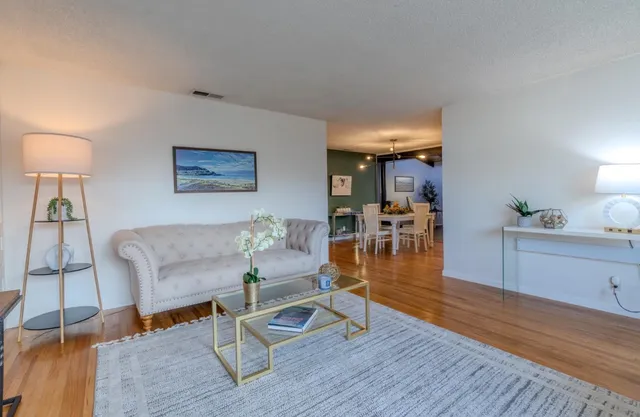 a view of a dining room with furniture and wooden floor