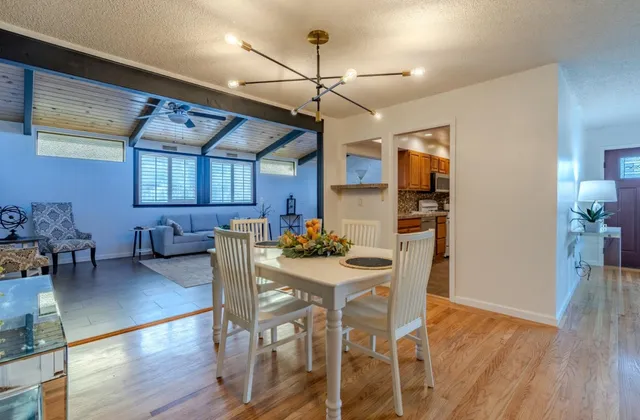 a kitchen with granite countertop cabinets stainless steel appliances a sink and wooden floor