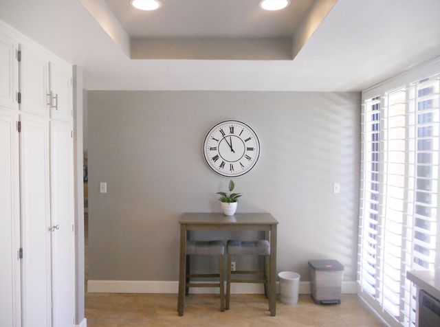 a clock on a wall next to a window