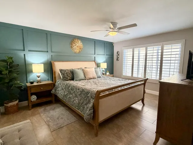 a bed sitting in a room next to a window