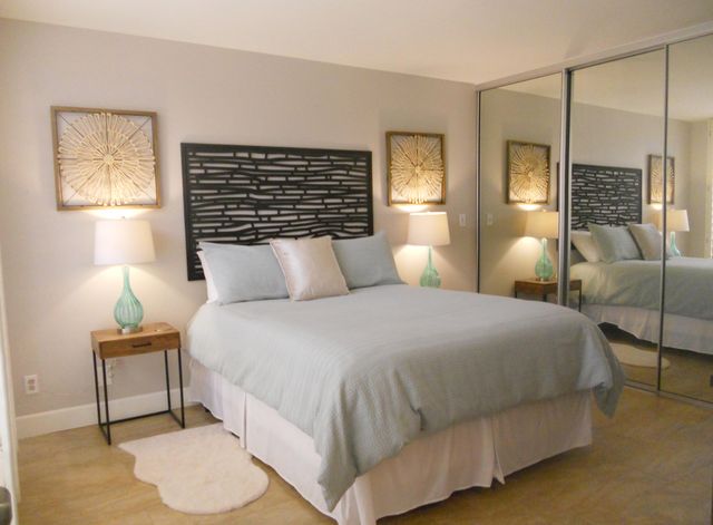 a bedroom with a bed and lamp with window