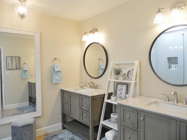 a bathroom with a sink mirror and a toilet