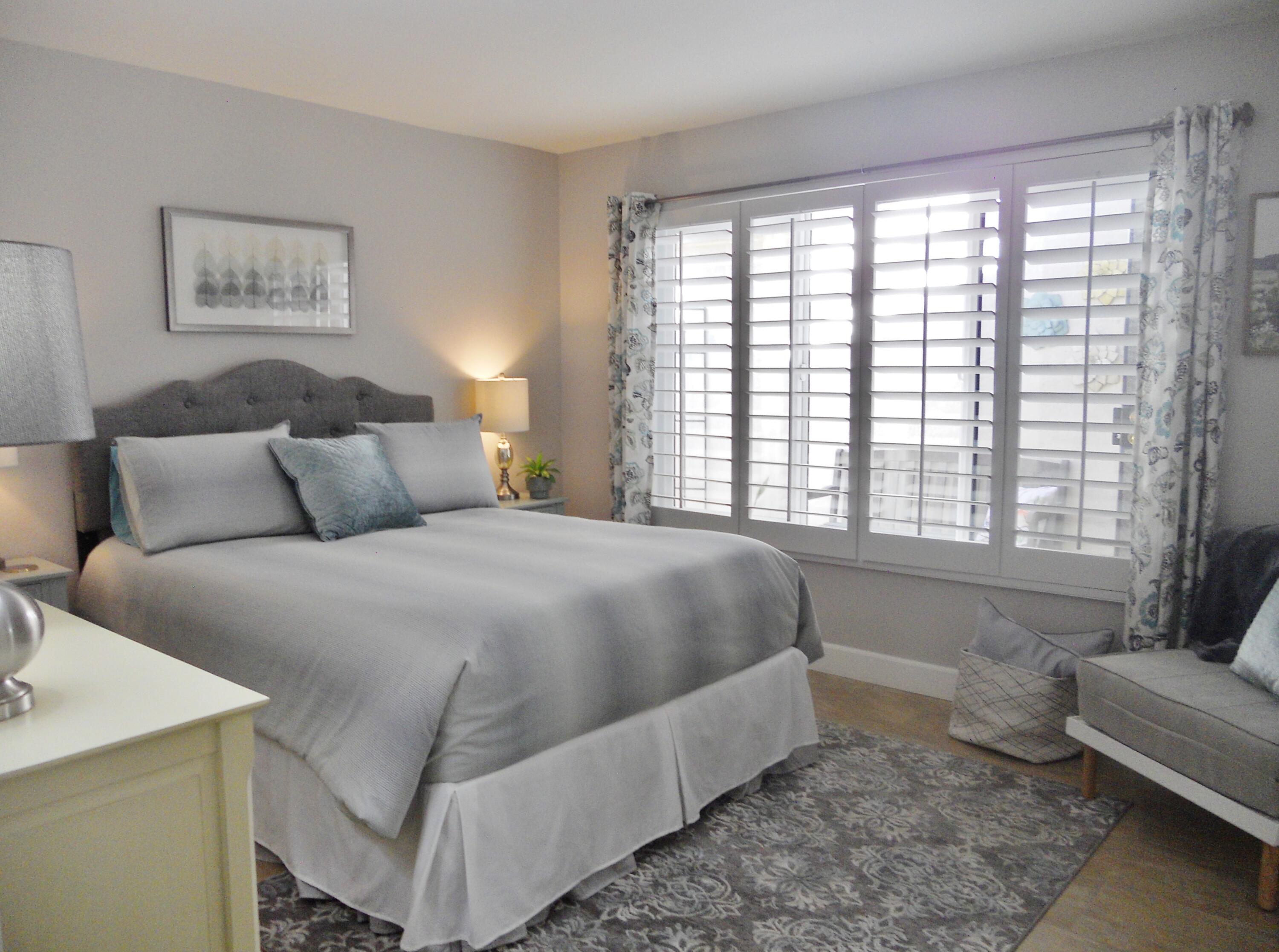 128 Castellana West Palm Desert, CA 92260 - Photo 19 of 20 a bedroom with a bed and glass window