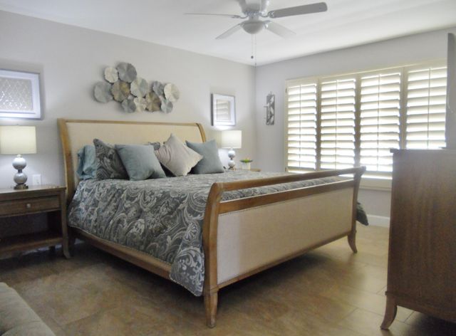 a living room with a bed and a window