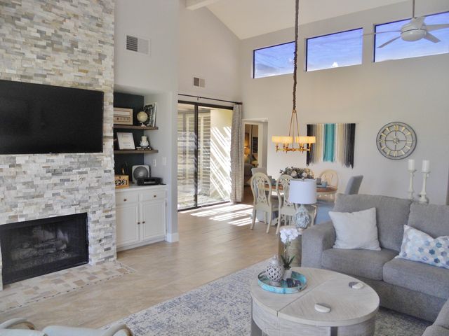 a living room with furniture a fireplace and a flat screen tv
