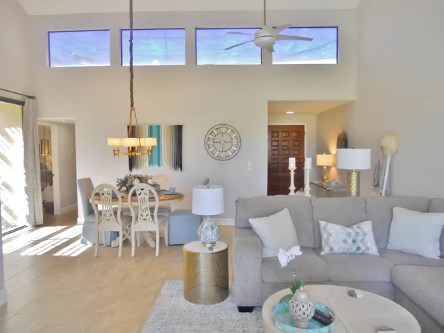 a living room with furniture a chandelier and a table