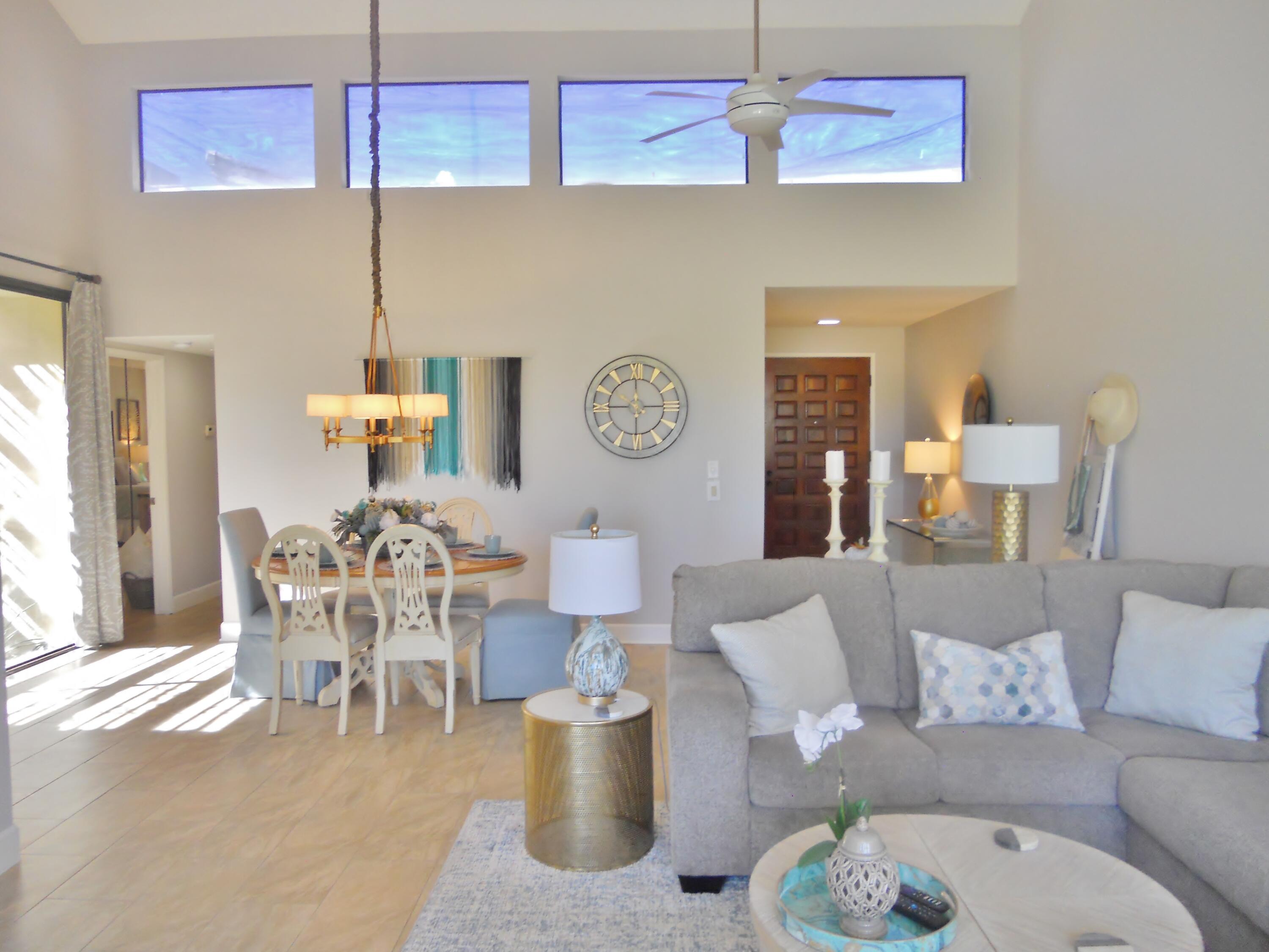 128 Castellana West Palm Desert, CA 92260 - Photo 9 of 20 a living room with furniture a chandelier and a table