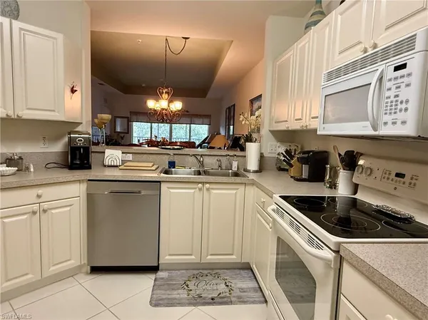 a kitchen with a sink cabinets and window