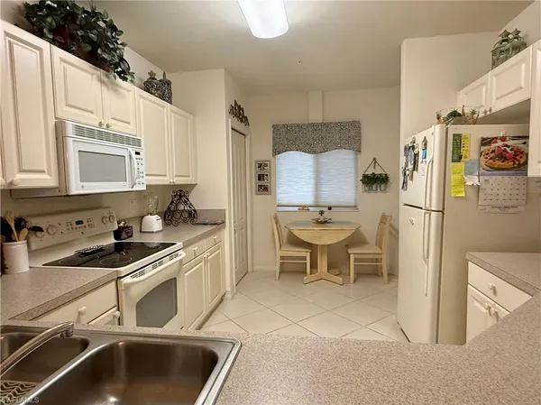 a kitchen with stainless steel appliances a stove a sink and a refrigerator