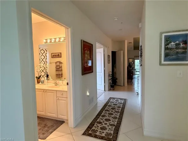 a hallway with wooden floor and a window
