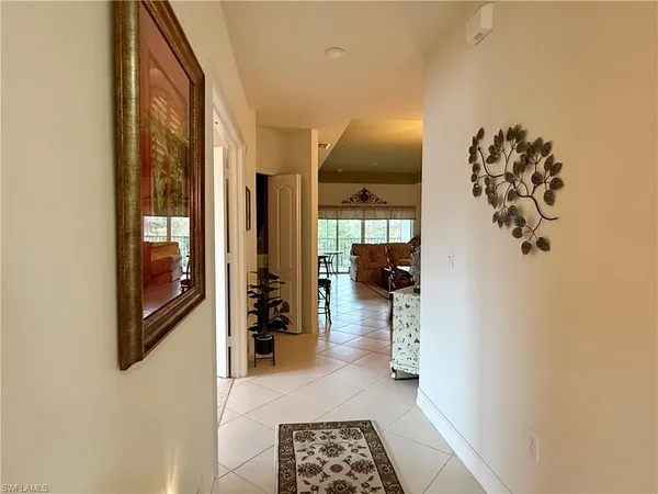 a hallway with a chandelier and a livingroom view