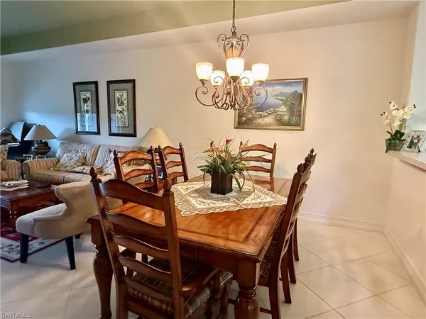 a view of a dining room with furniture and chandelier