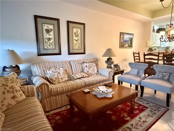 a living room with furniture rug and window