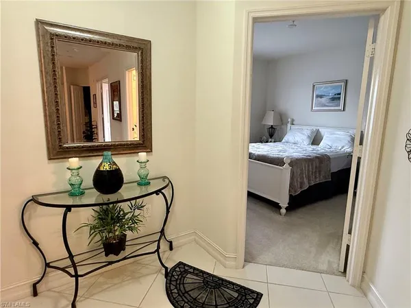 a bedroom with a bed and a mirror in it