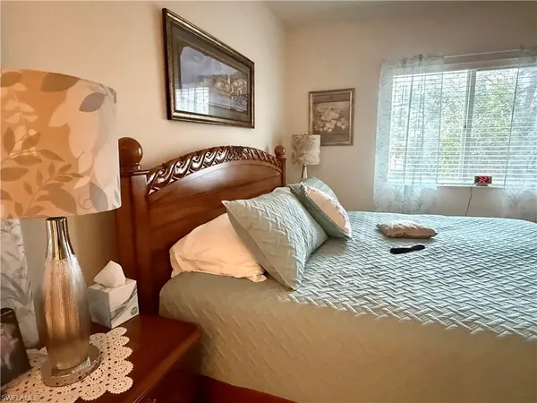 a bedroom with furniture and a window