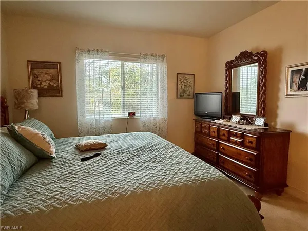 a bedroom with furniture and a window