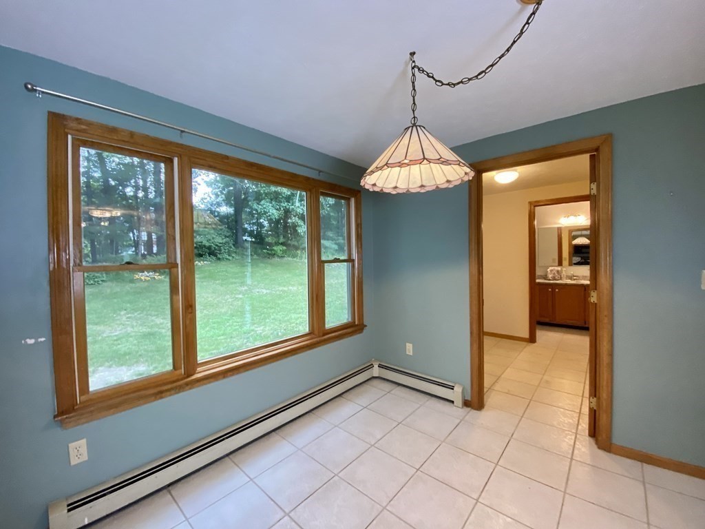 22 Old Homestead Road Groton, MA 01450 - Photo 12 of 36 a view of a room that has a large window and a table