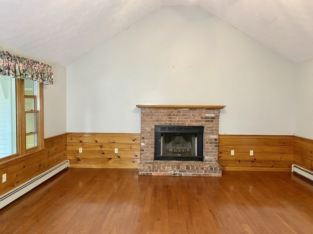 22 Old Homestead Road Groton, MA 01450 - Photo 15 of 36 a view of an empty room with a fireplace and wooden floor