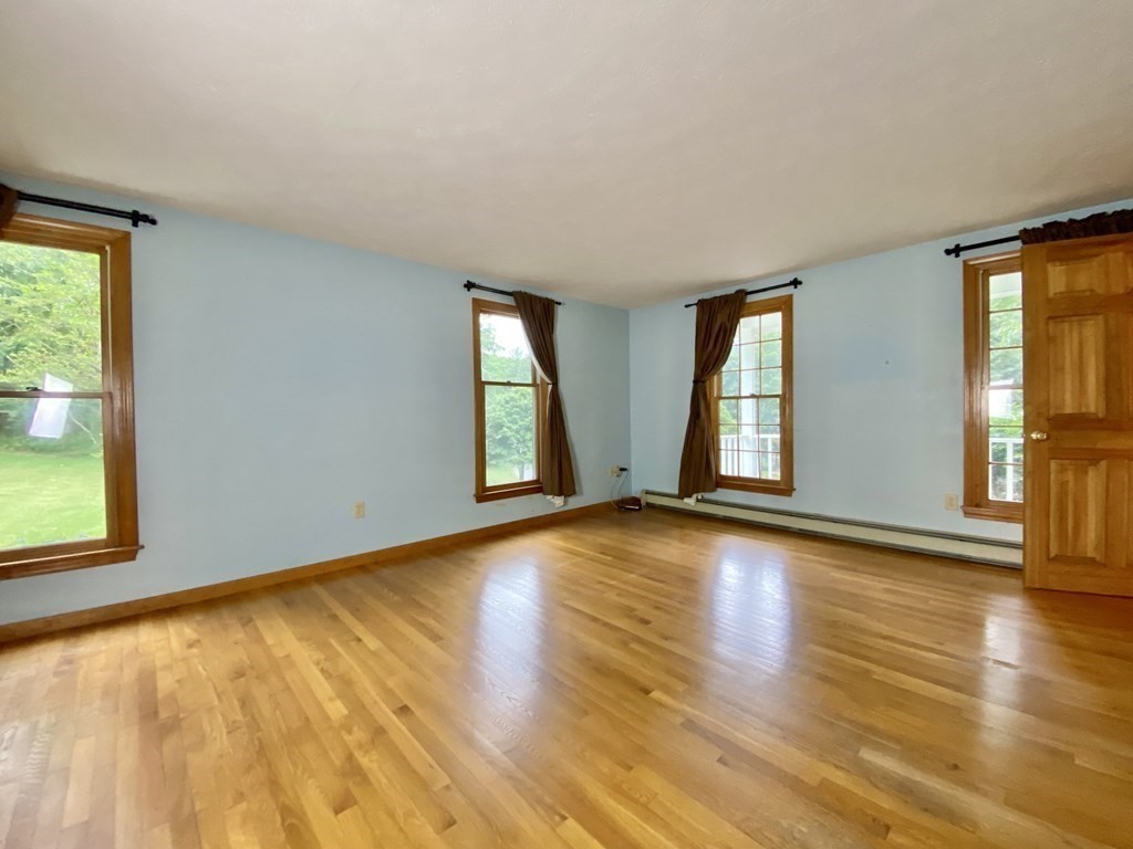 22 Old Homestead Road Groton, MA 01450 - Photo 19 of 36 a view of an empty room with glass door and wooden floor