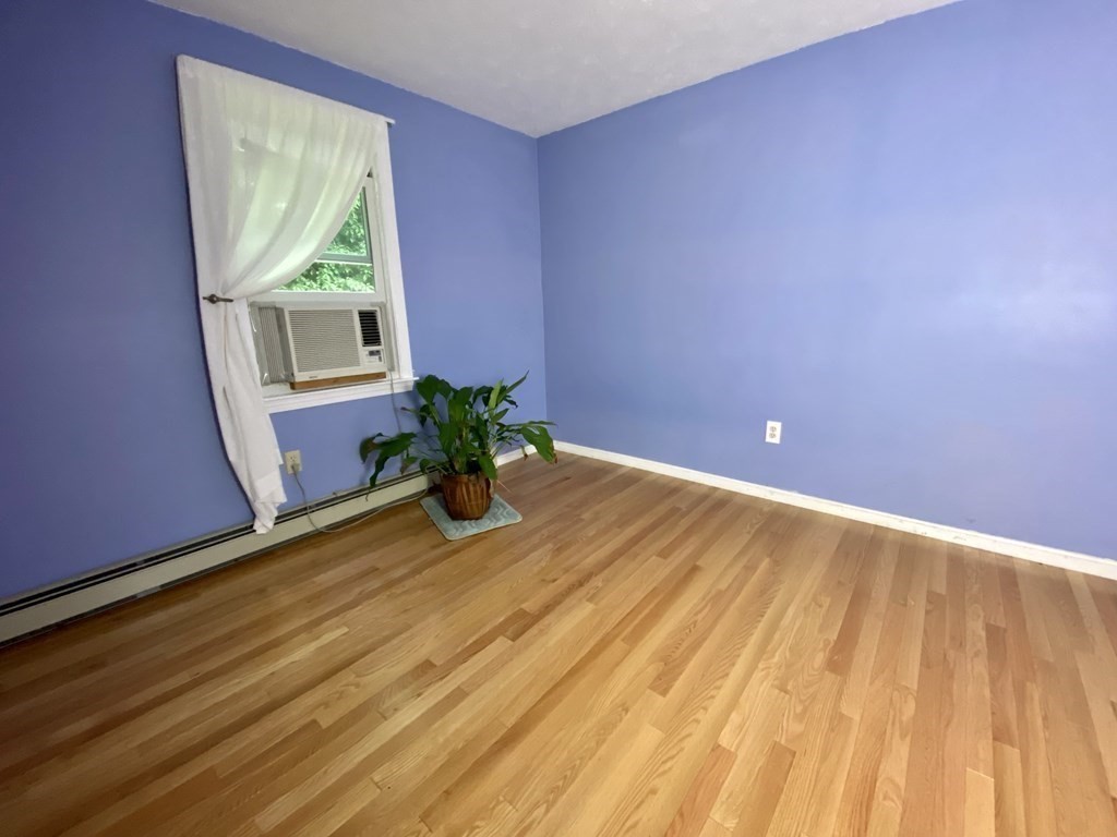 22 Old Homestead Road Groton, MA 01450 - Photo 25 of 36 a view of a room with wooden floor and a potted plant