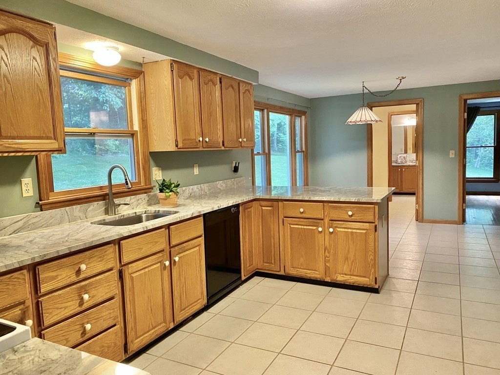 22 Old Homestead Road Groton, MA 01450 - Photo 9 of 36 a spacious bathroom with a granite countertop sink and a mirror