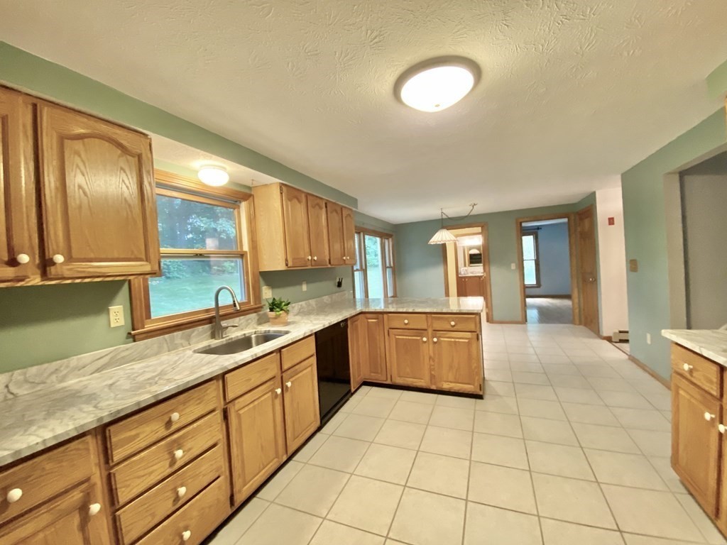 22 Old Homestead Road Groton, MA 01450 - Photo 10 of 36 a large kitchen with a stove a sink dishwasher and a refrigerator