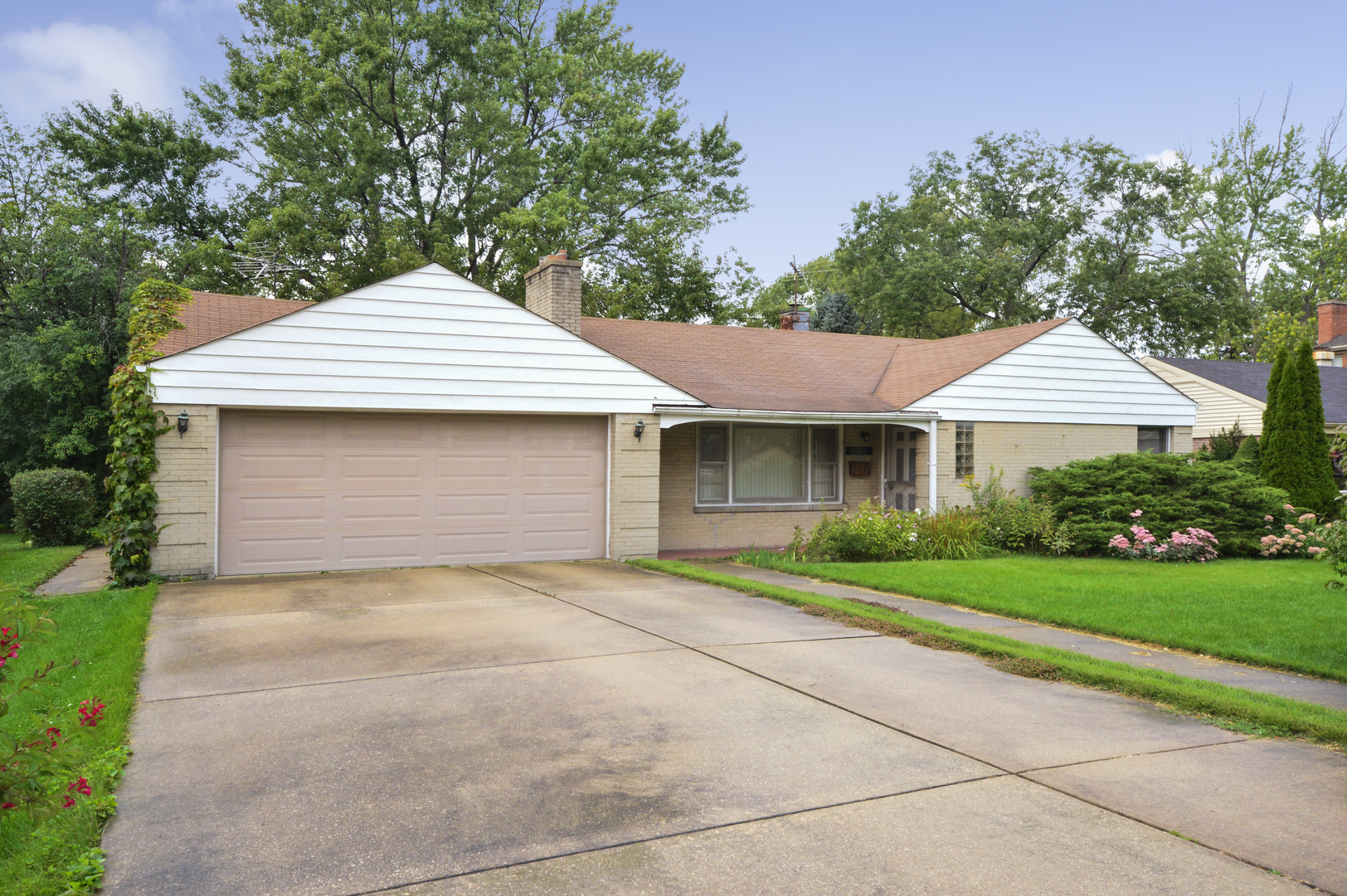 1746 Good Avenue Park Ridge, IL 60068 - Photo 1 of 11 a front view of a house with a yard and garage
