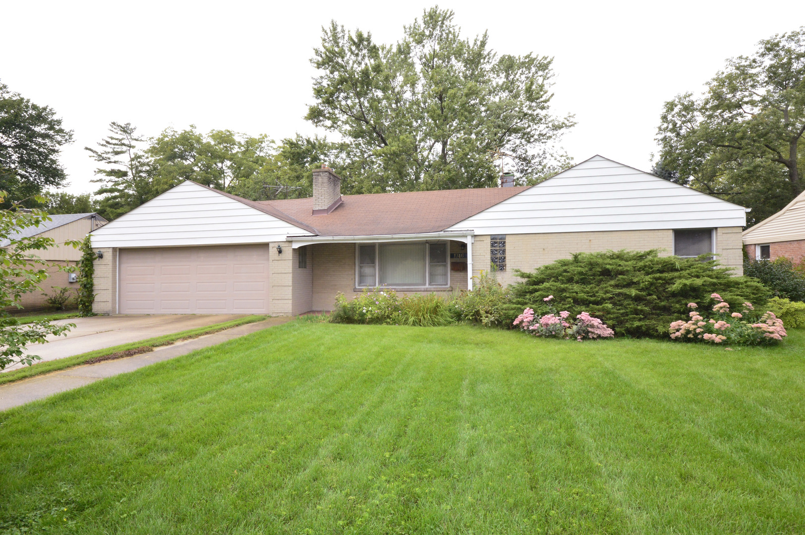 1746 Good Avenue Park Ridge, IL 60068 - Photo 2 of 11 a front view of a house with garden