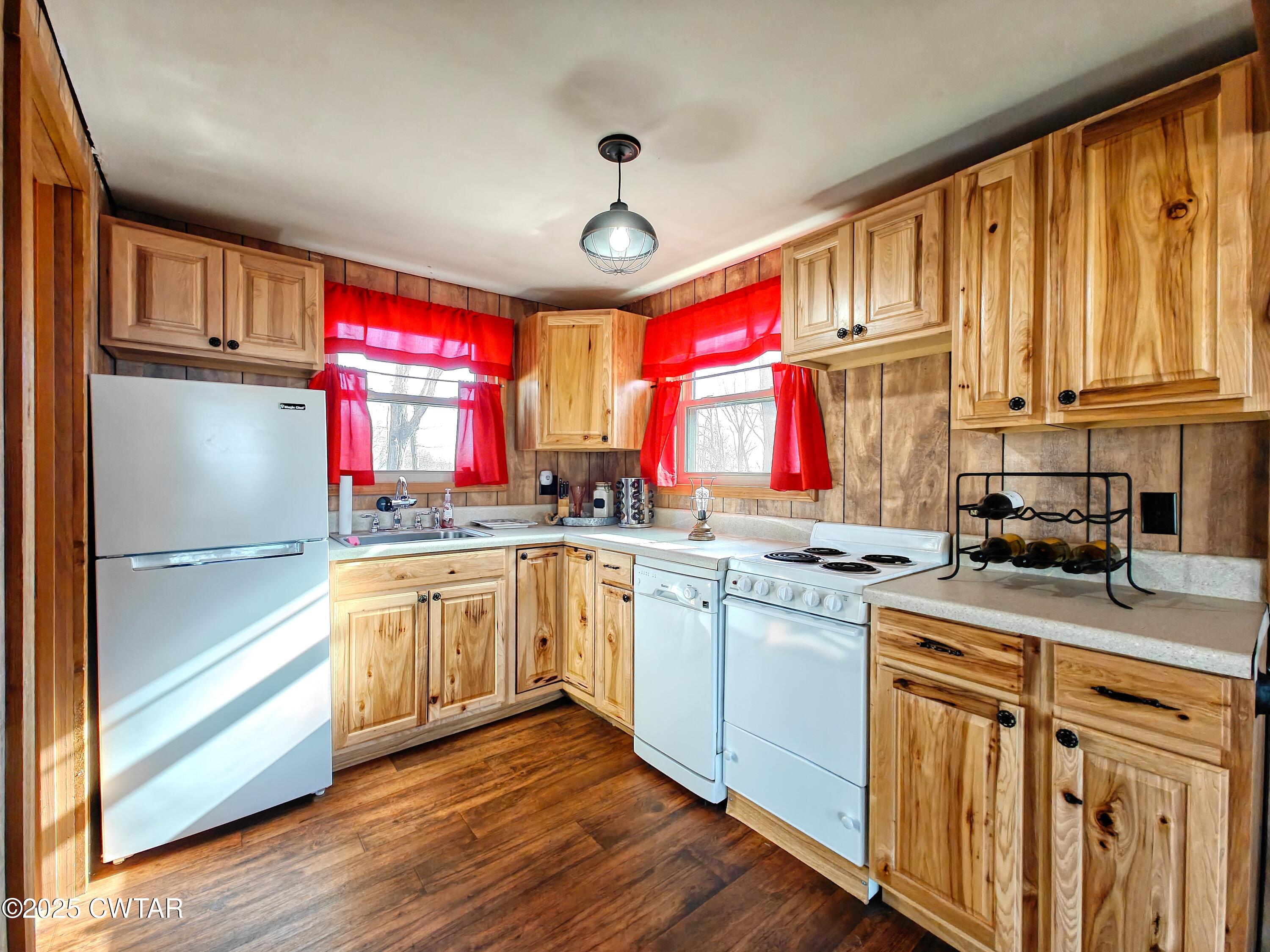 103 Grace Lane Eva, TN 38333 - Photo 17 of 25 a kitchen with stainless steel appliances granite countertop a stove a sink dishwasher and cabinets with wooden floor