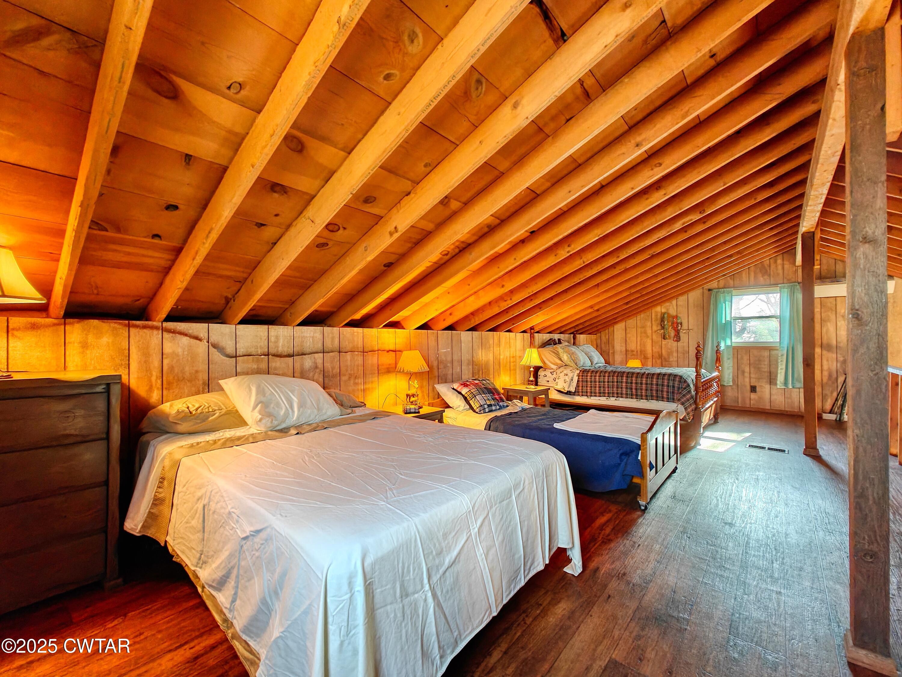 103 Grace Lane Eva, TN 38333 - Photo 21 of 25 a bedroom with a bed and wooden floor