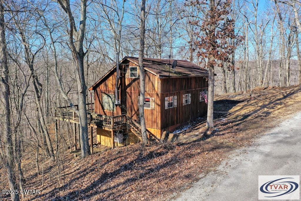 103 Grace Lane Eva, TN 38333 - Photo 5 of 25 a view of a wooden house with a large tree