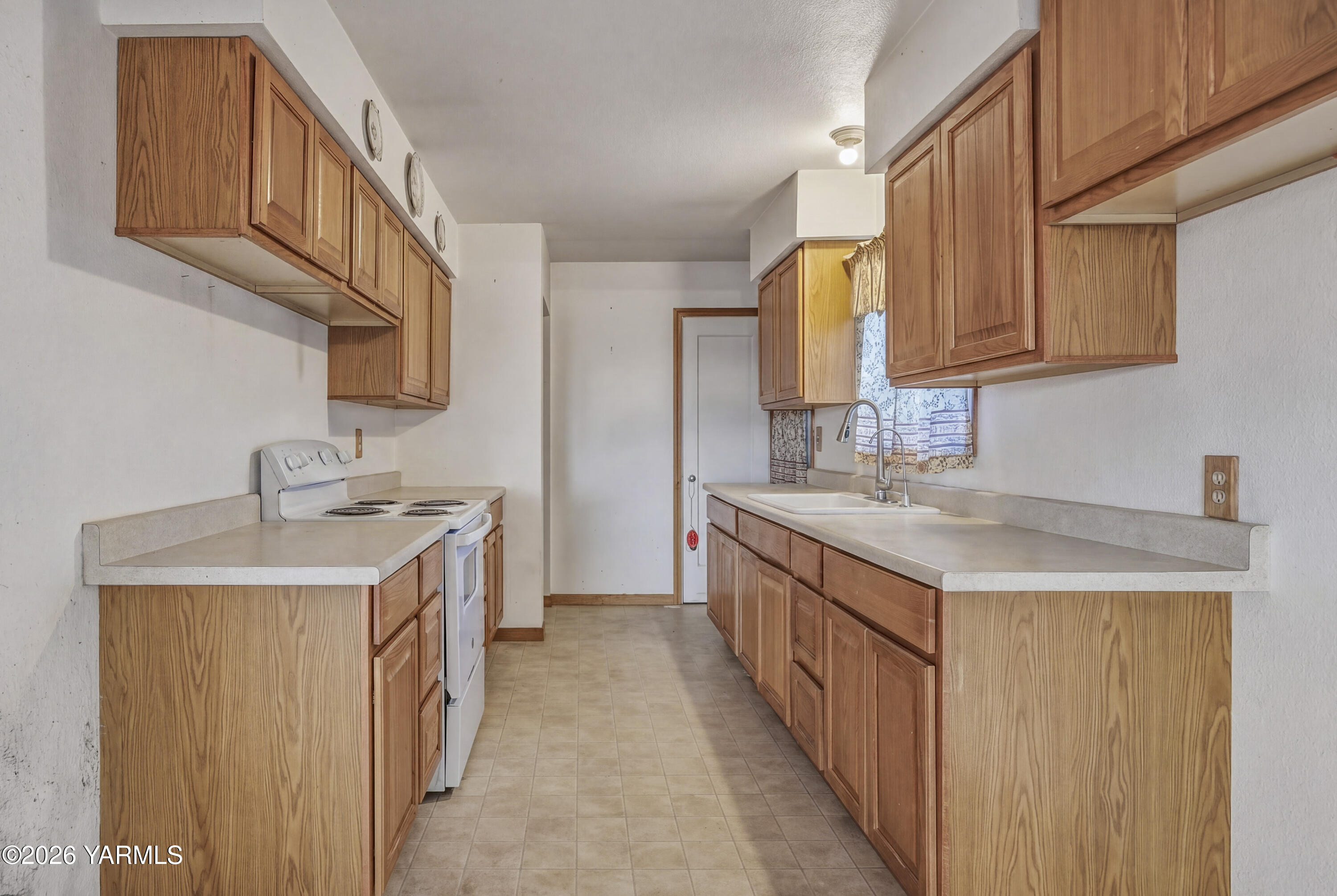 36322 D Mccall Road North Benton City, WA 99320 - Photo 29 of 39 a kitchen with a sink stove top oven and cabinets