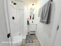 a view of a bathroom with tub shower