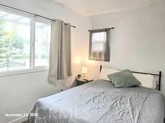 a bedroom with a large bed and a large window